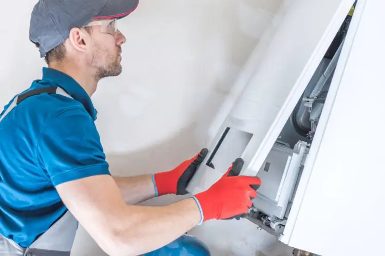 House Heating Unit Repair:condensing boilers, heater, furnace, central heating, gas, repair, fix, installing, installer, technician, job, labor, technology, unit, device, equipment, professional, industry, worker, men, caucasian, household